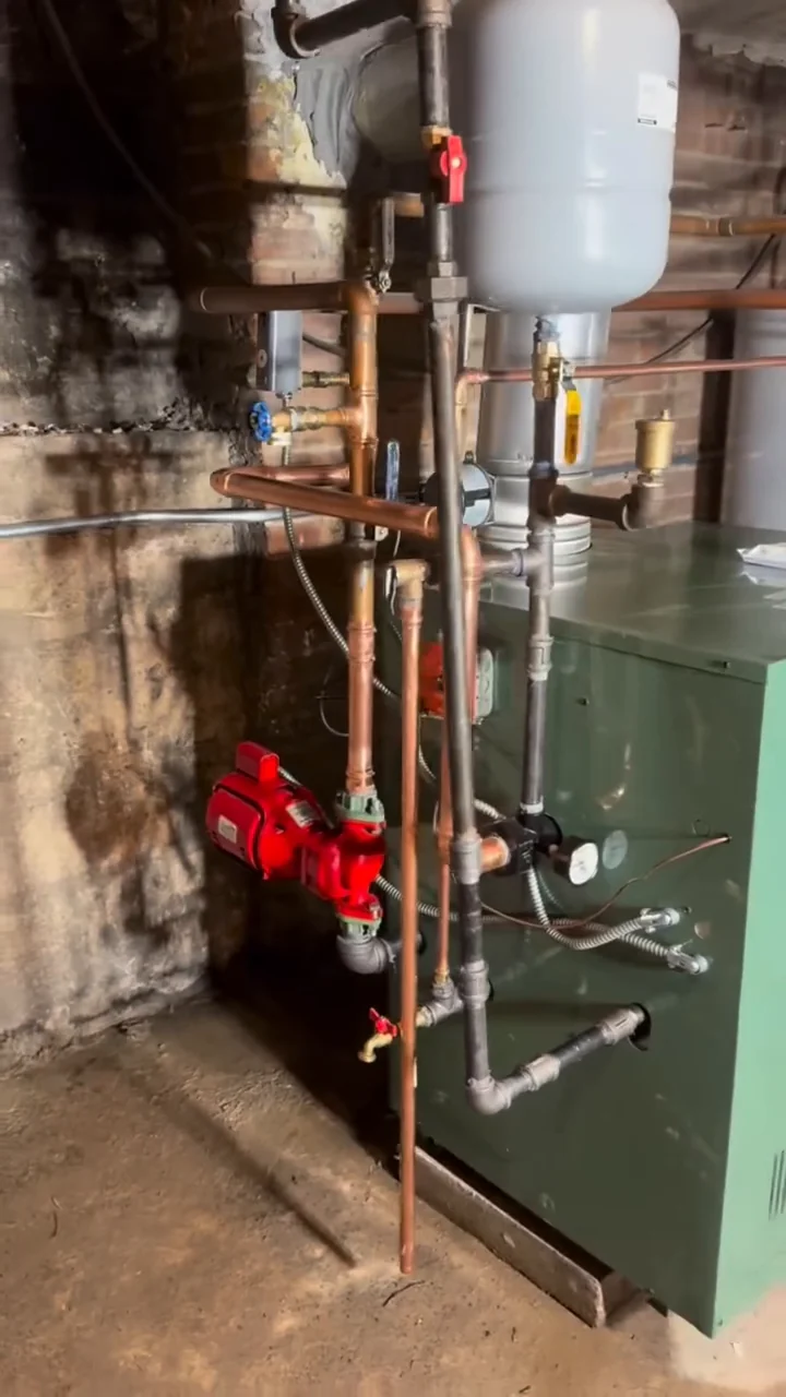Pipework and controls beside a floor-standing boiler.