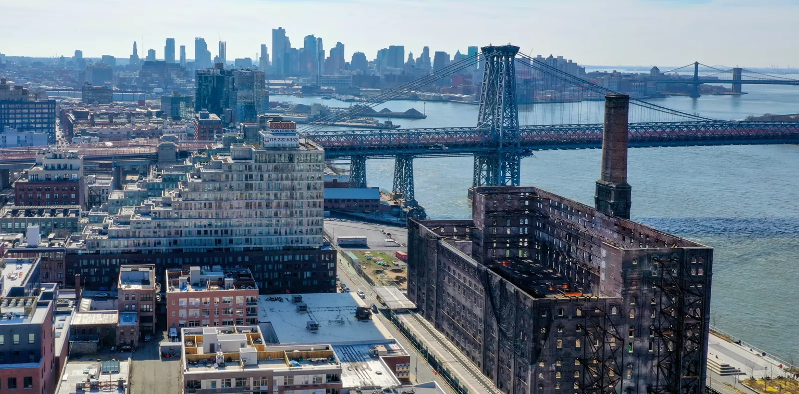 Williamsburg waterfront buildings and bridge in the supplied neighborhood photograph.
