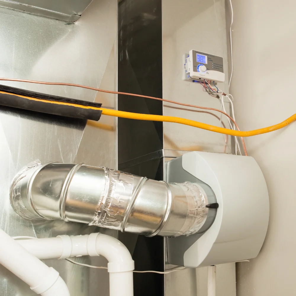 Humidifier installed beside HVAC ductwork.